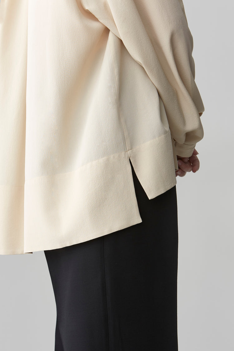 Close-up of the slit in sleeve seams on HELEN oversized silk blouse, emphasizing the fine craftsmanship.