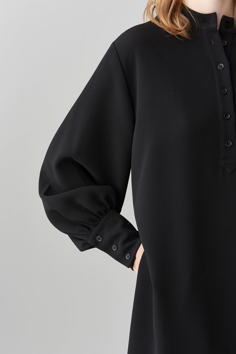 Detailed view of the exaggerated cuffs on the blouson sleeves of JOYCE midi dress.