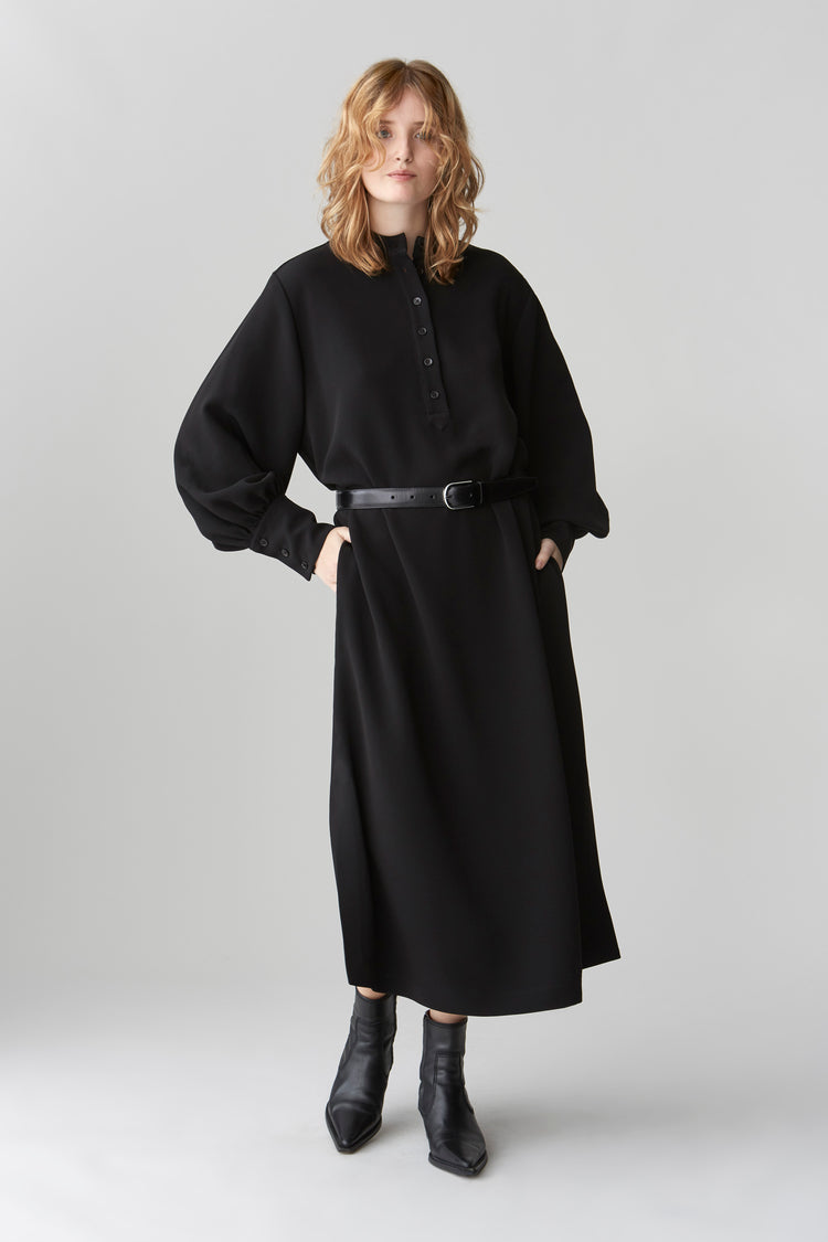 Model wearing JOYCE midi dress with blouson sleeves, featuring a standing collar and button placket, in a relaxed fit and with a black leather belt.